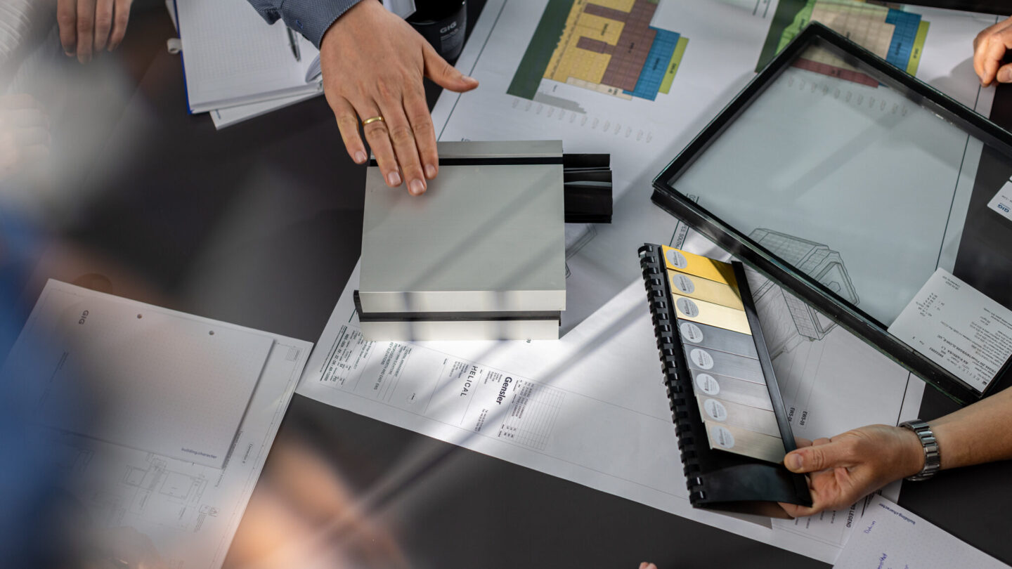 Glass and color samples for a element façade project are being discussed.