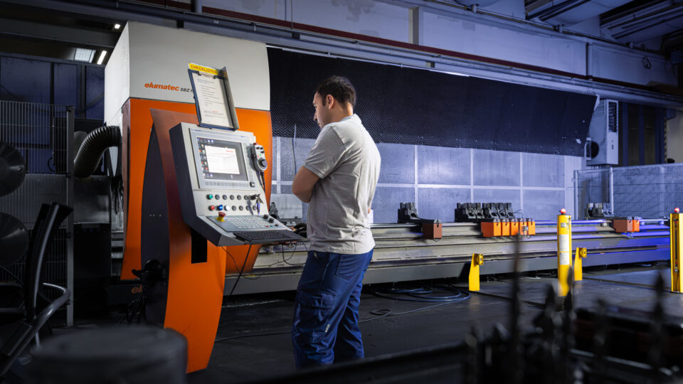 Employee at the rod processing center reading the work orders.
