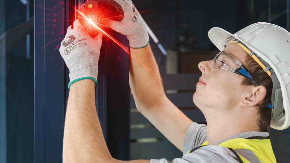 GIG skilled worker measuring the existing structure for the façade retrofit.