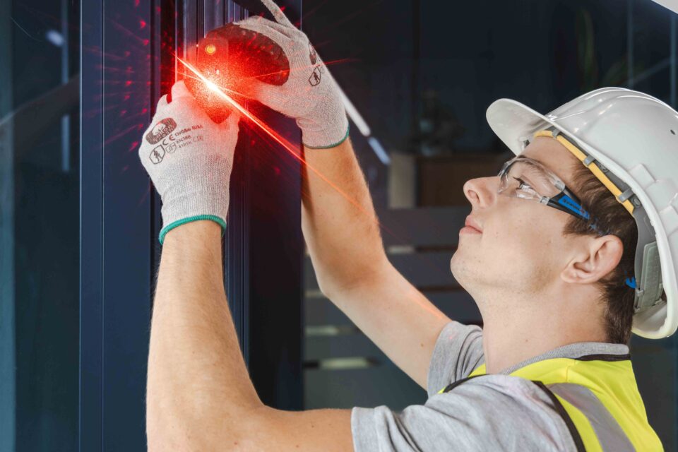 GIG skilled worker measuring the existing structure for the façade retrofit.
