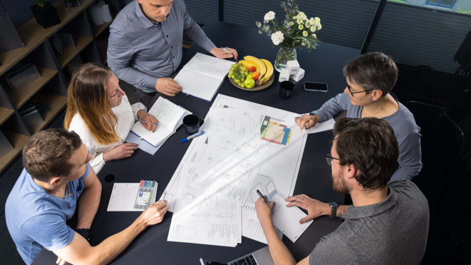 The team discusses the developed façade plans.